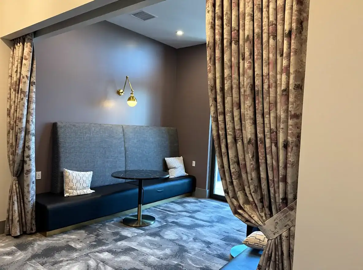 Finished drapery framing a dark lounge interior