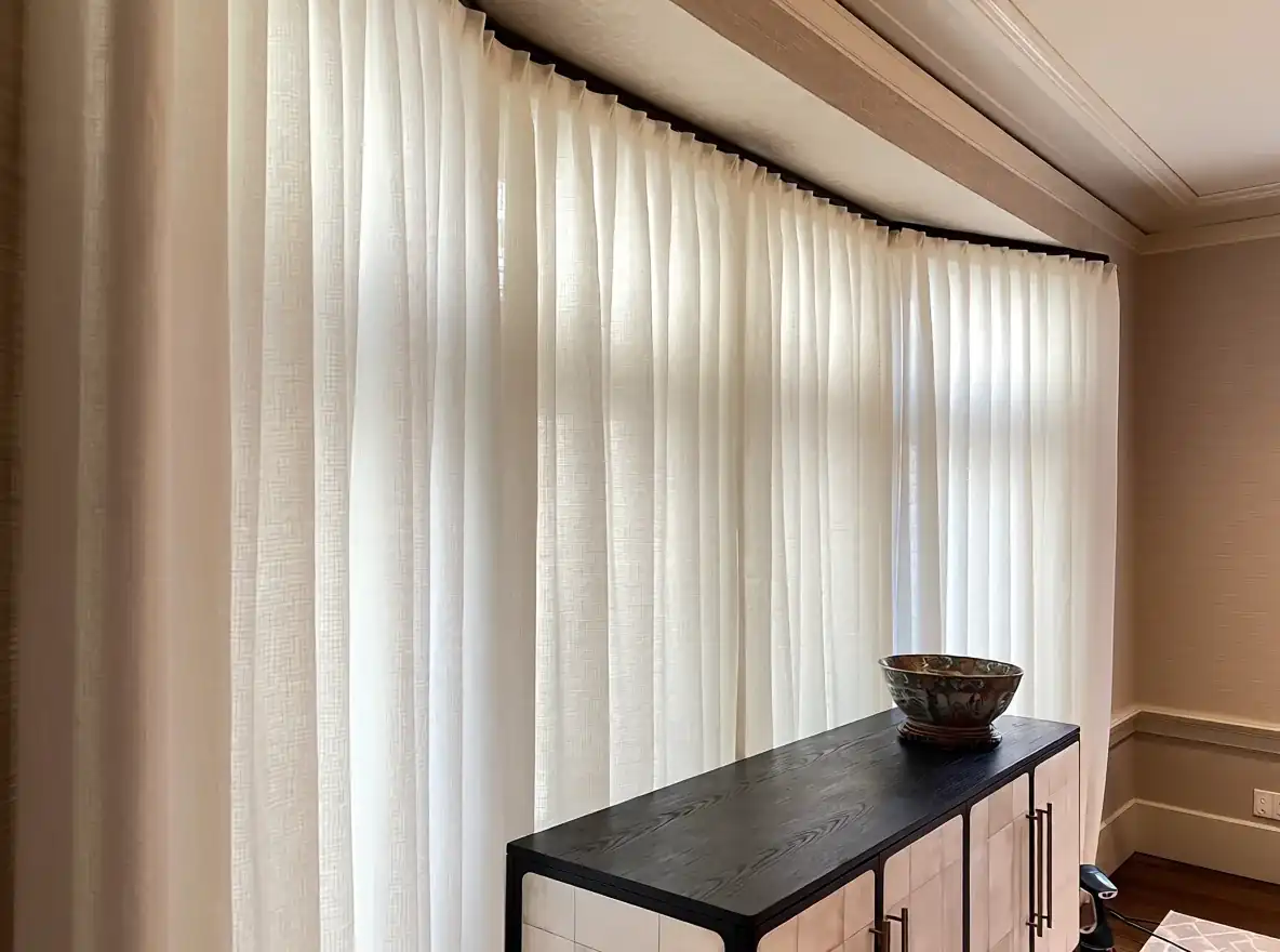 Sheer window treatments installed across a living room