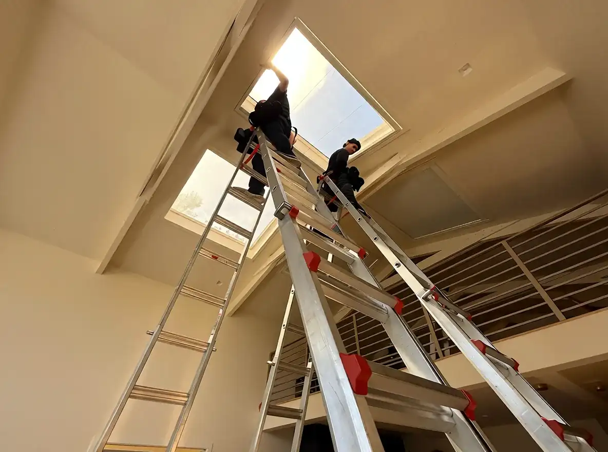 Installer working on a commercial skylight treatment