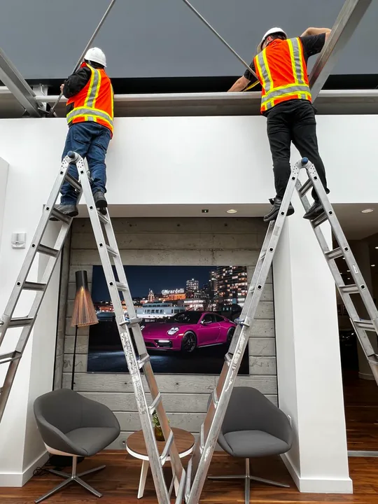 Lutron shade installation being completed in a commercial interior
