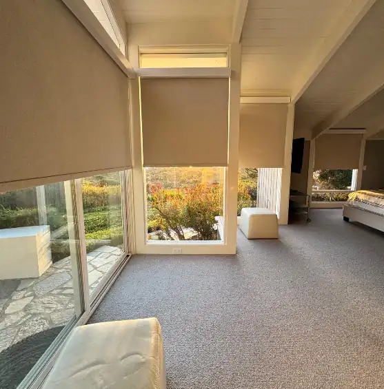 Roller shades installed across bedroom windows