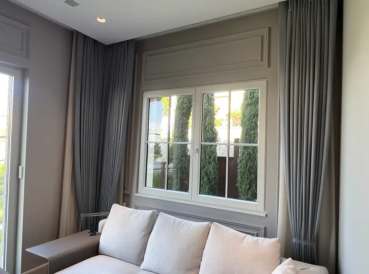 Tailored gray drapery framing a bright residential window