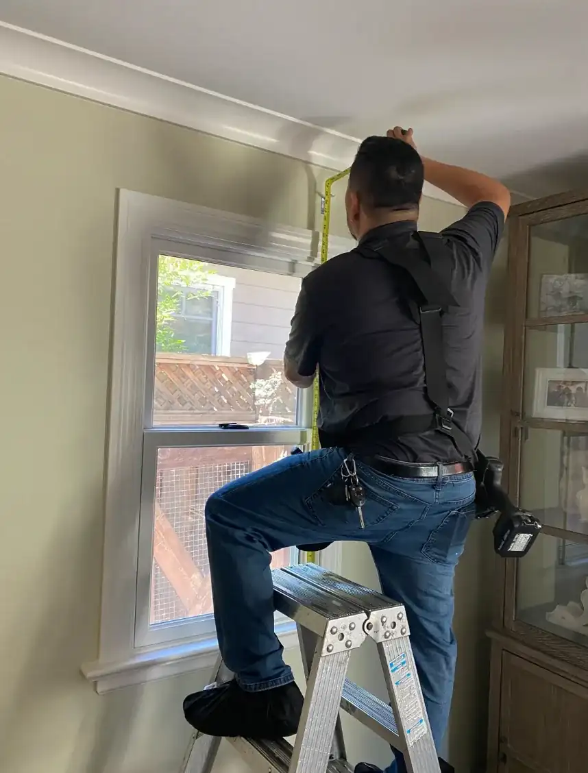 Alro installer installing a residential window shade